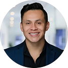 Smiling professional in dark blazer indoors