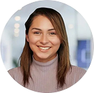 Smiling woman in purple turtleneck in office