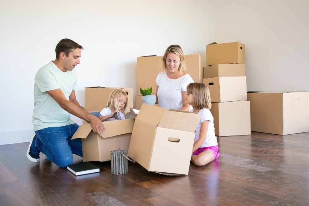 Family unpacking boxes in new home